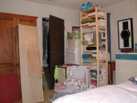bedroom stacked with stuff
